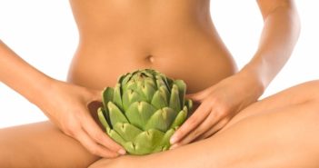 Young Nude Woman Holding Artichoke in Lap