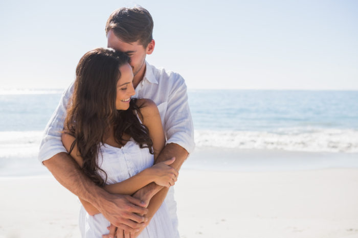 Loving couple cuddling at the beach