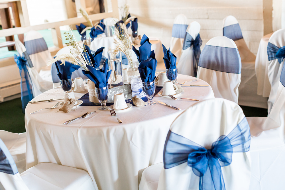 Banquet hall decorated for wedding in white and blue.