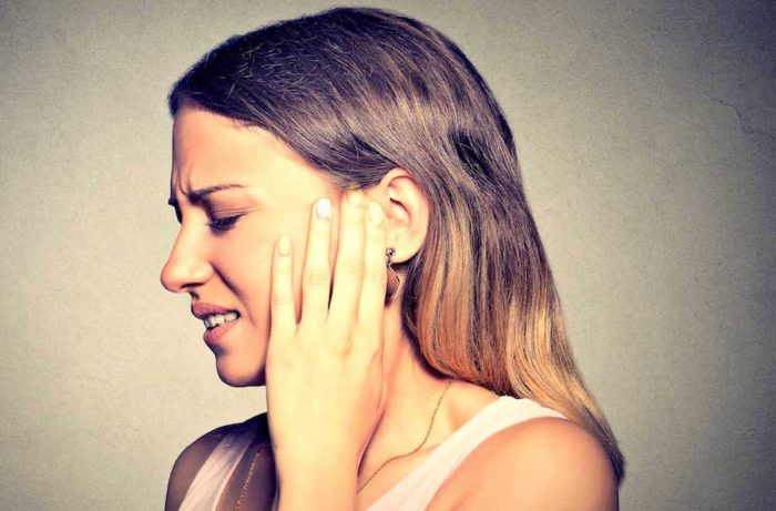 side profile sick young woman having ear pain