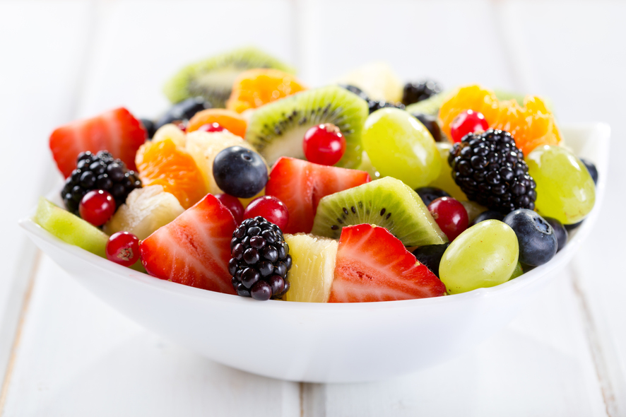 bowl of fruit salad on wooden table