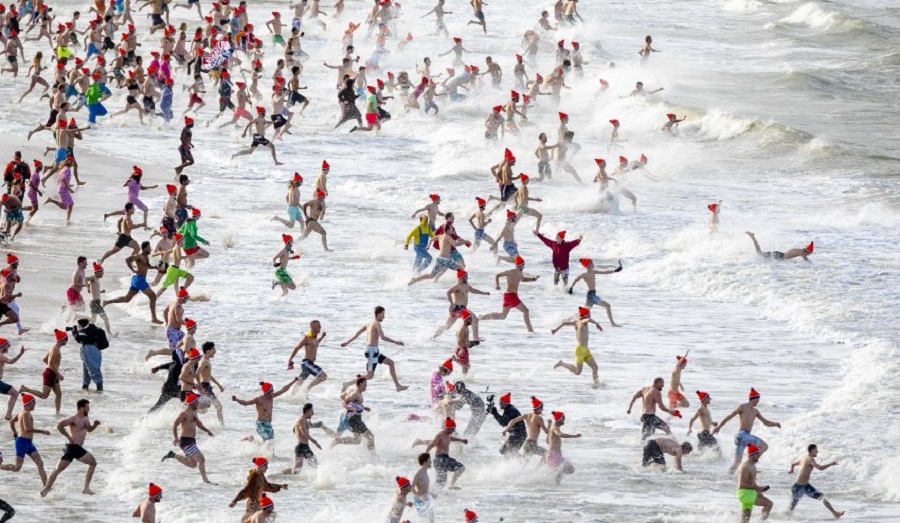 Mandatory Credit: Photo by Bart Maat/EPA-EFE/REX/Shutterstock (9304760c) People run towards the North Sea during the Nieuwjaarsduik (New Year's Dive) on New Year's Day in Scheveningen, the Netherlands, 01 January 2018. New Year celebration in Scheveningen, Netherlands - 01 Jan 2018