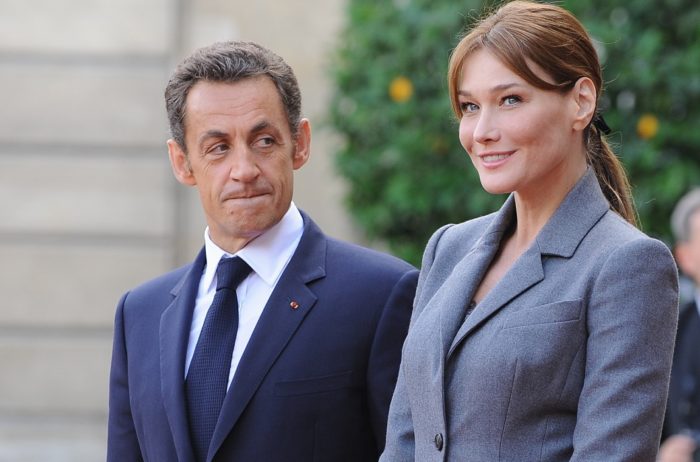 12 Sep 2008, Paris, France --- French President Nicolas Sarkozy and First Lady Carla Bruni-Sarkozy stand on the red carpet outside the Elysee Palace as Pope Benedict XVI departs. --- Image by © Christian Liewig/Liewig Media Sports/Corbis