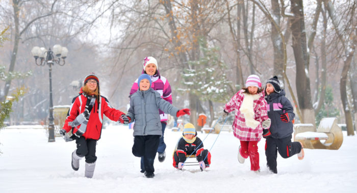 group-of-children-and-adult-playing-on-snow-in-winter-time-y-2