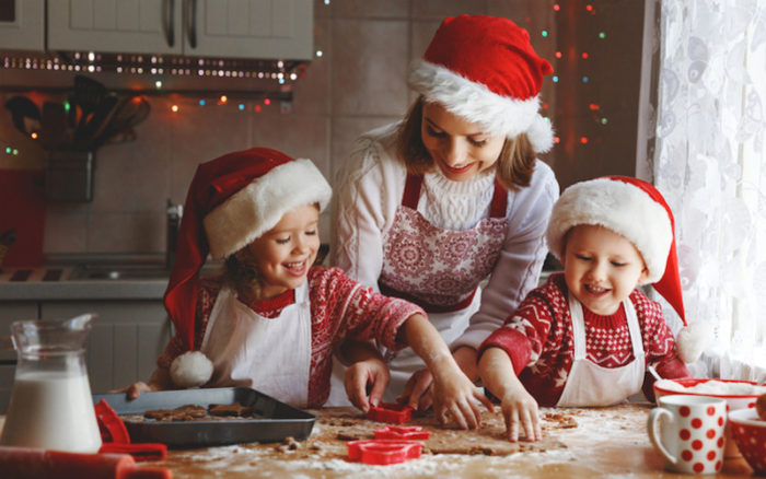 happy family mother and children son and daughter bake cookies for Christmas