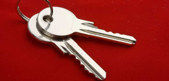 two keys on a ring over red background