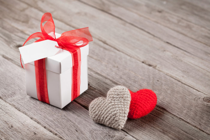 Valentines day gift box and hearts on wood
