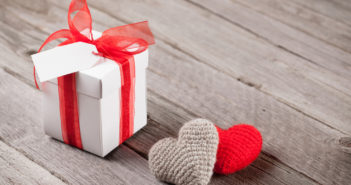 Valentines day gift box and hearts on wood