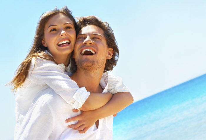 An attractive couple playing around on the beach