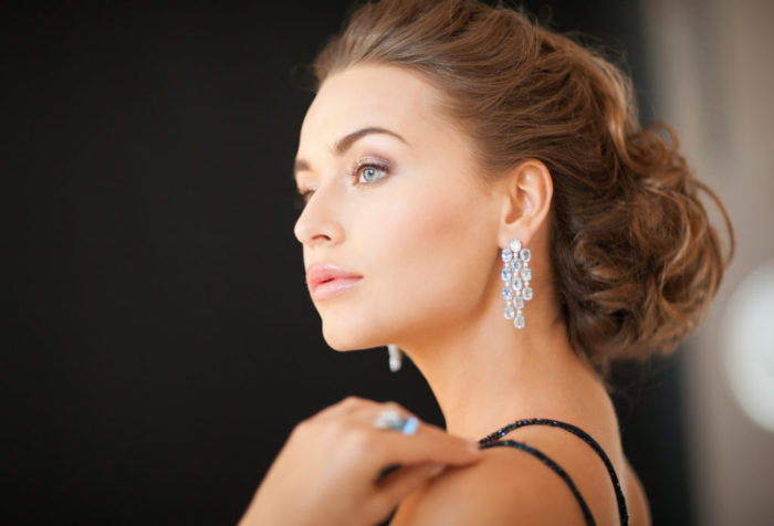 beautiful woman in evening dress wearing diamond earrings