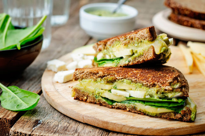 grilled rye sandwiches with cheese, spinach, pesto, avocado and