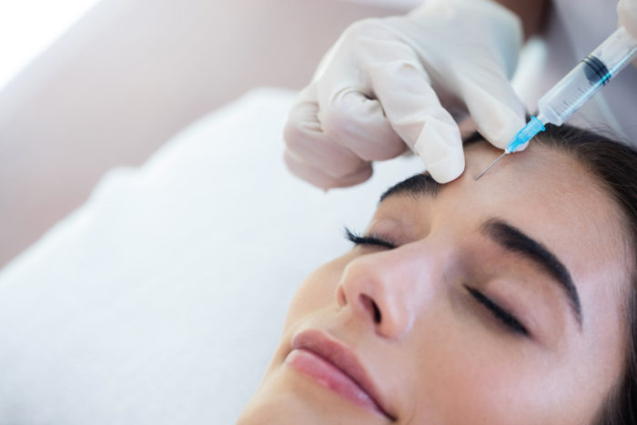 Woman receiving botox injection at spa