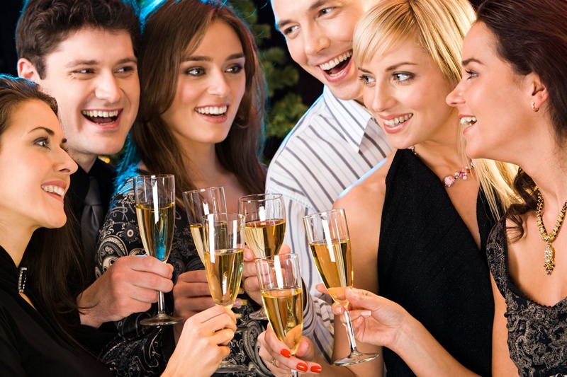 Portrait of six happy people holding glasses of champagne making a toast