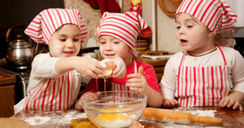 Three little chefs enjoying in the kitchen making big mess. Litt