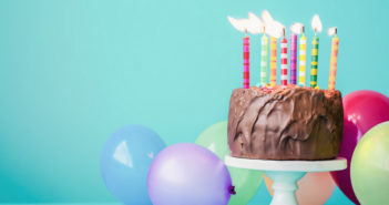 Chocolate birthday cake with colorful candles