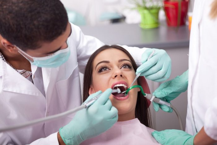 dentist curing a girls teeth